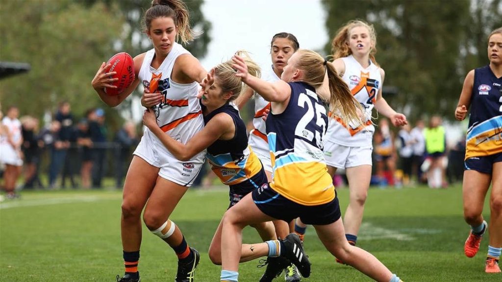 Girls playing Aussie Rules (AFL)