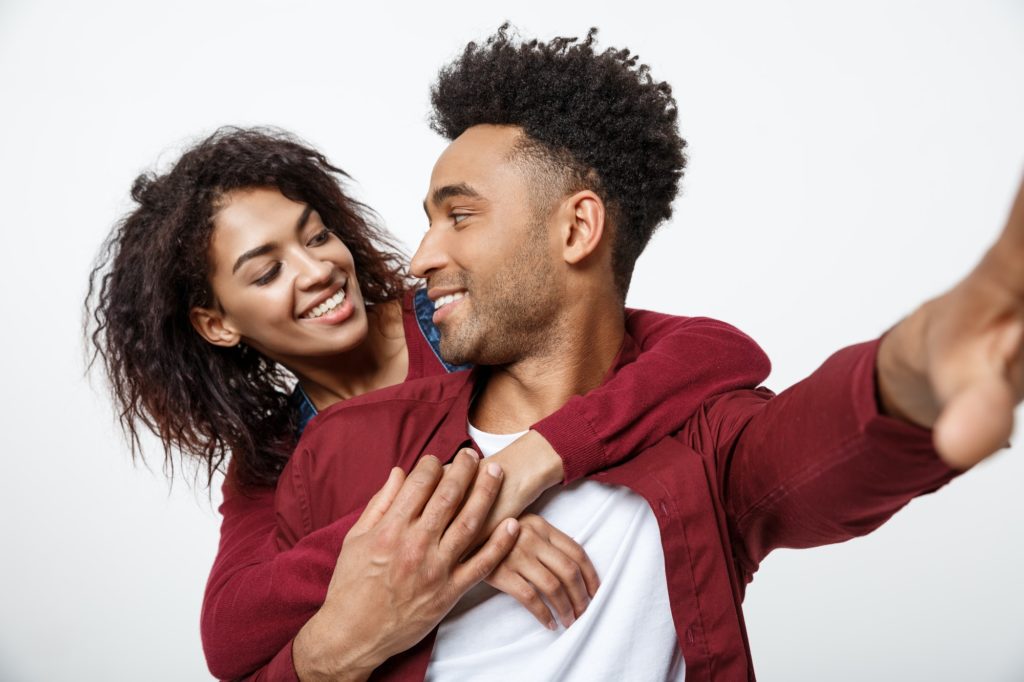 Close up attractive African American couple making a selfie with cute gesture