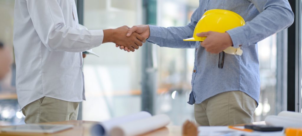Architects and contractors shake hands to work.