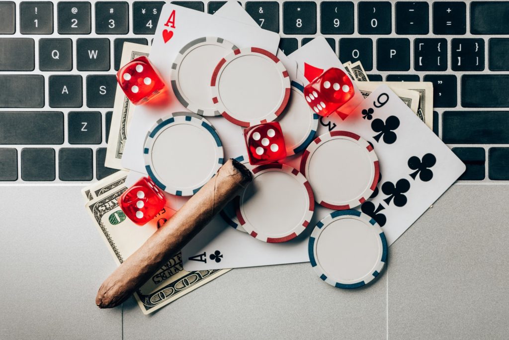 Online gambling concept with chips and money on laptop