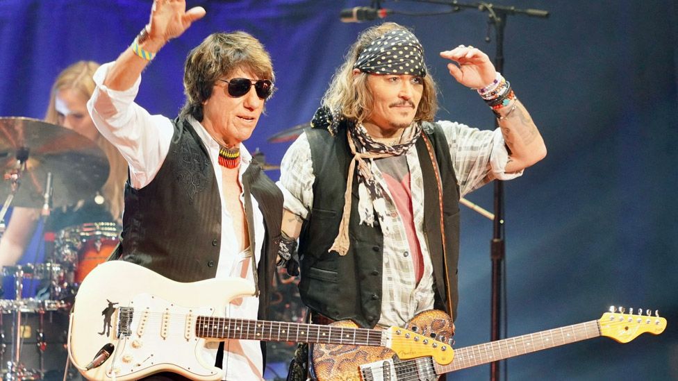 Jeff Beck (left) and Johnny Depp with black and white polka-dot headband (right).