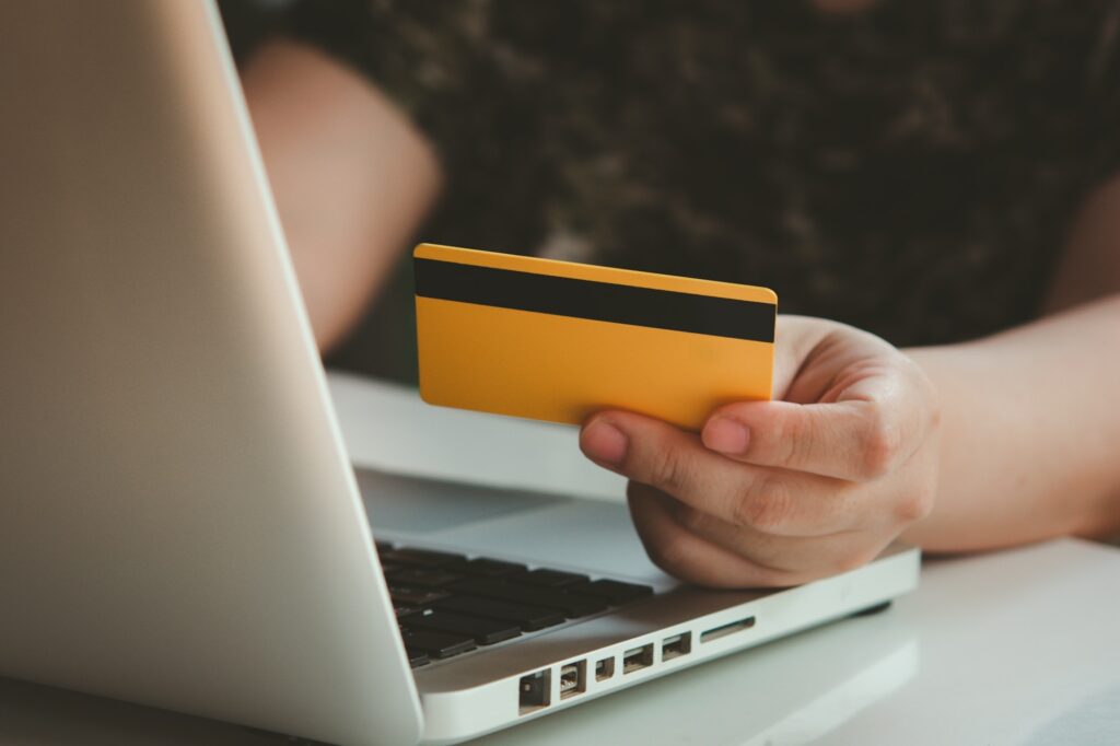 Credit card payment. Woman hands holding credit card and using laptop. Online shopping