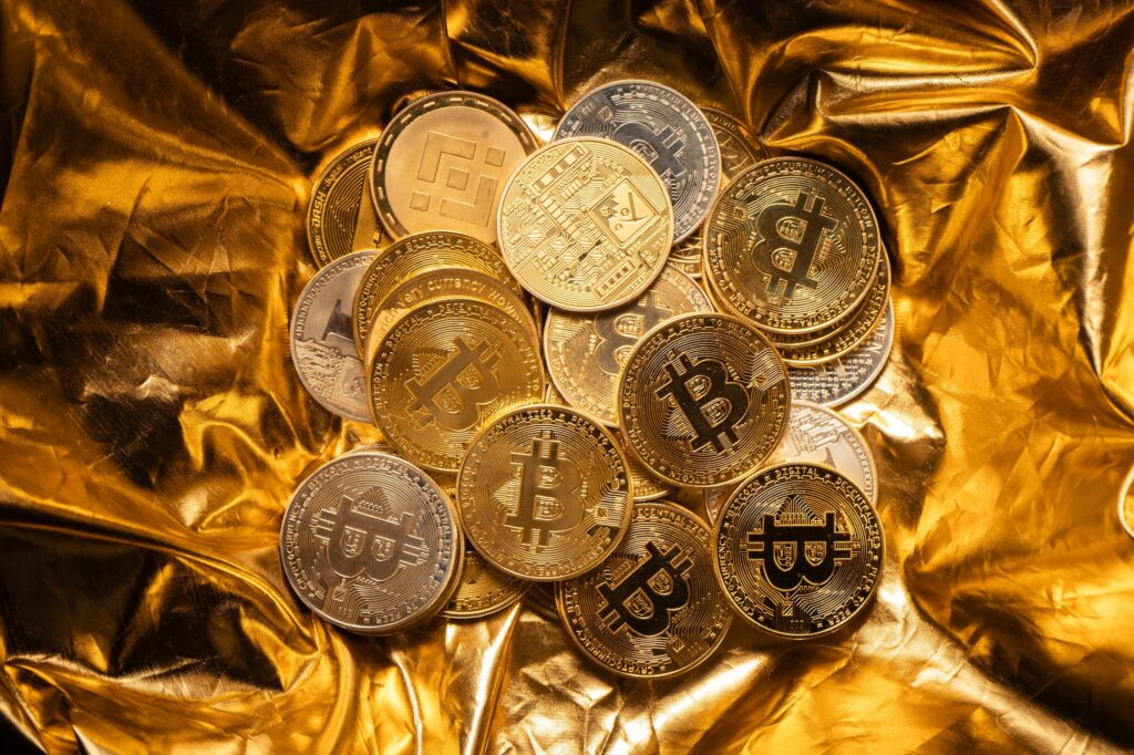 Cryptocurrency coin and bitcoin on golden background