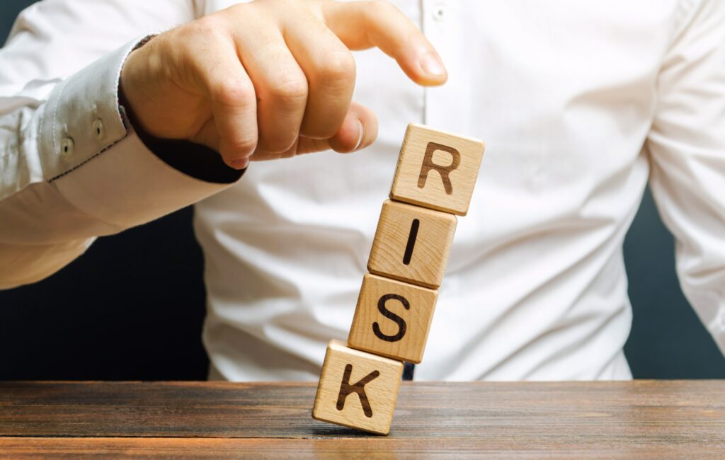 Man removes blocks with the word Risk