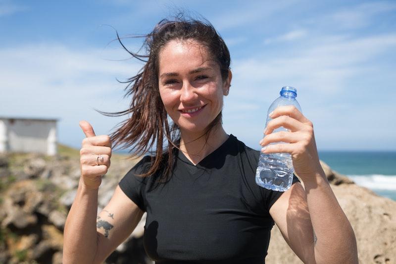 Woman, thumbs up, with water bottle