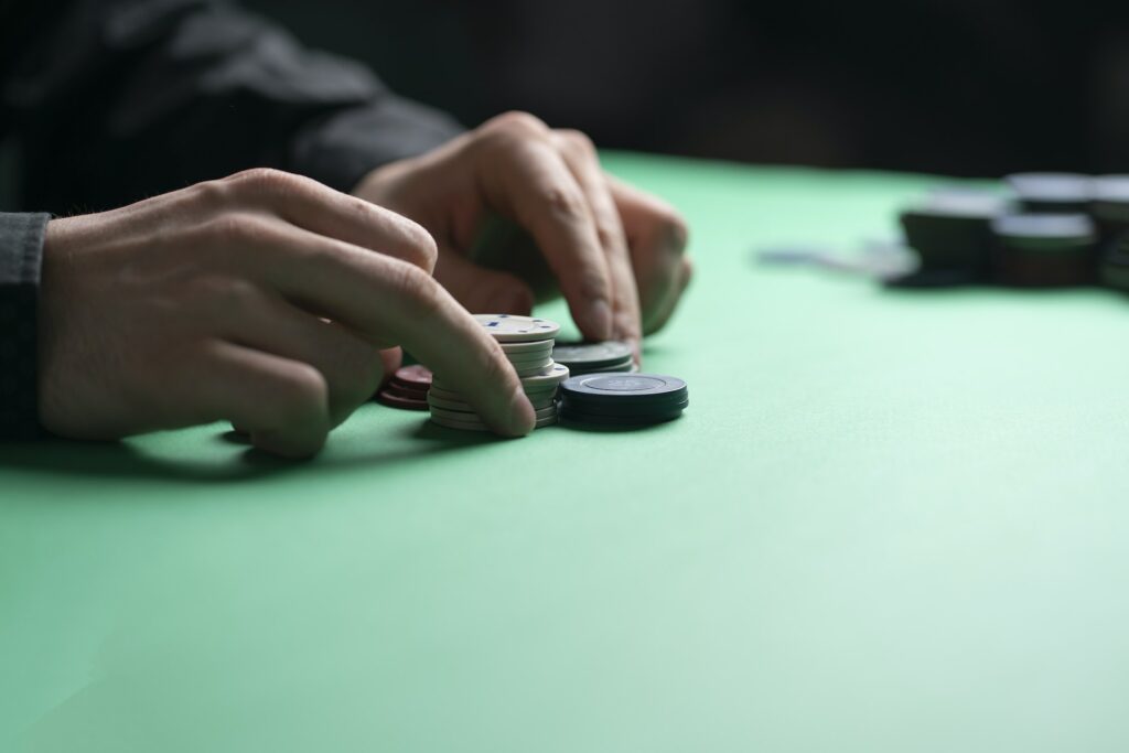 a poker player holding casino chips in hand, winning the game