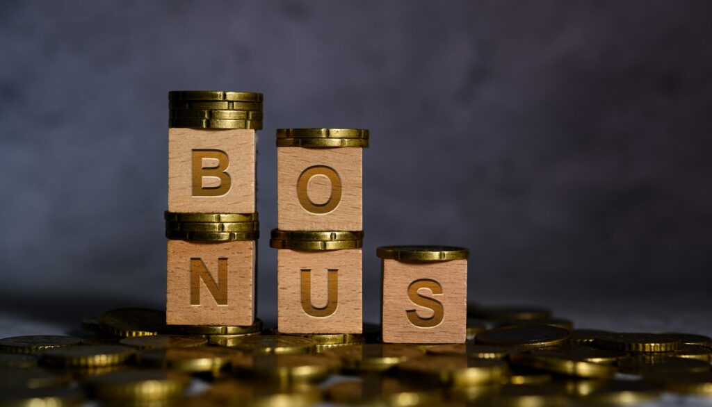 Bonus word alphabet wooden cube letters placed on a gold coin