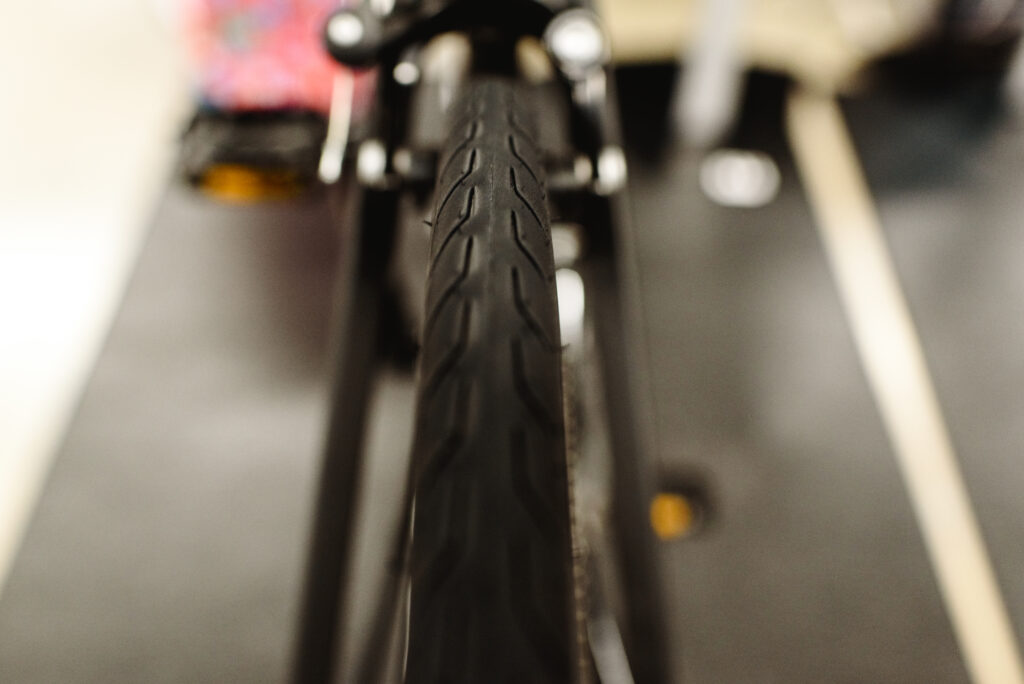 Tires and rear brake of a road bike.