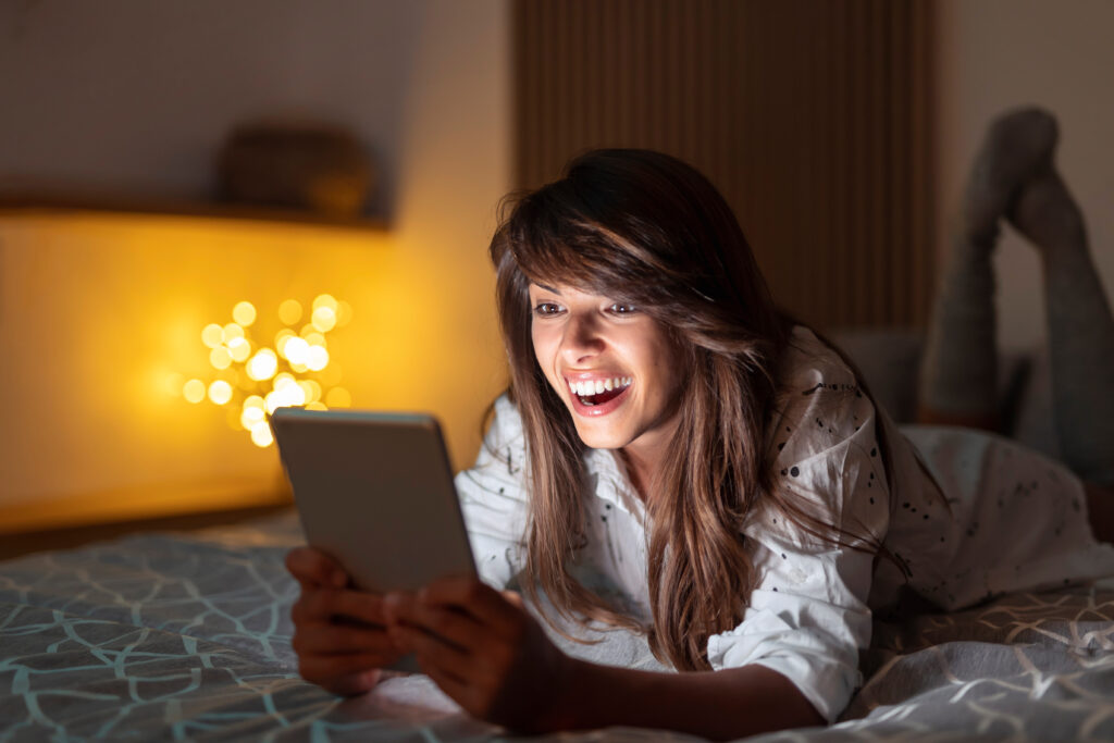 Woman reading an ebook in bed at night
