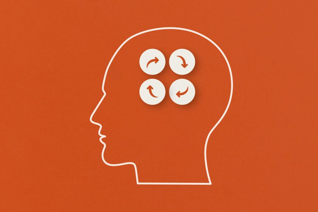 Human heads with arrows cycle concept on red background.