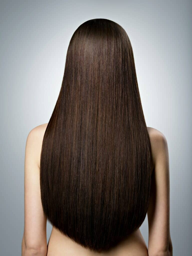 Woman with long brown straight hair. Rear view