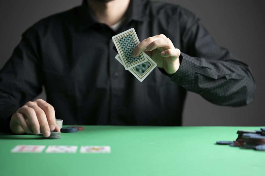 a poker player in the casino playing a game and holding cards
