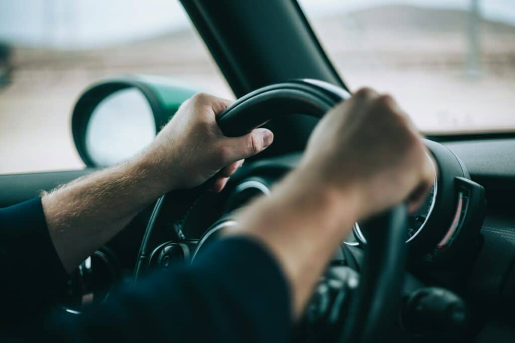 Man hands on the steering wheel