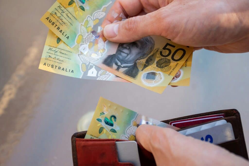Hands holding wallet with australian dollars and make a payment