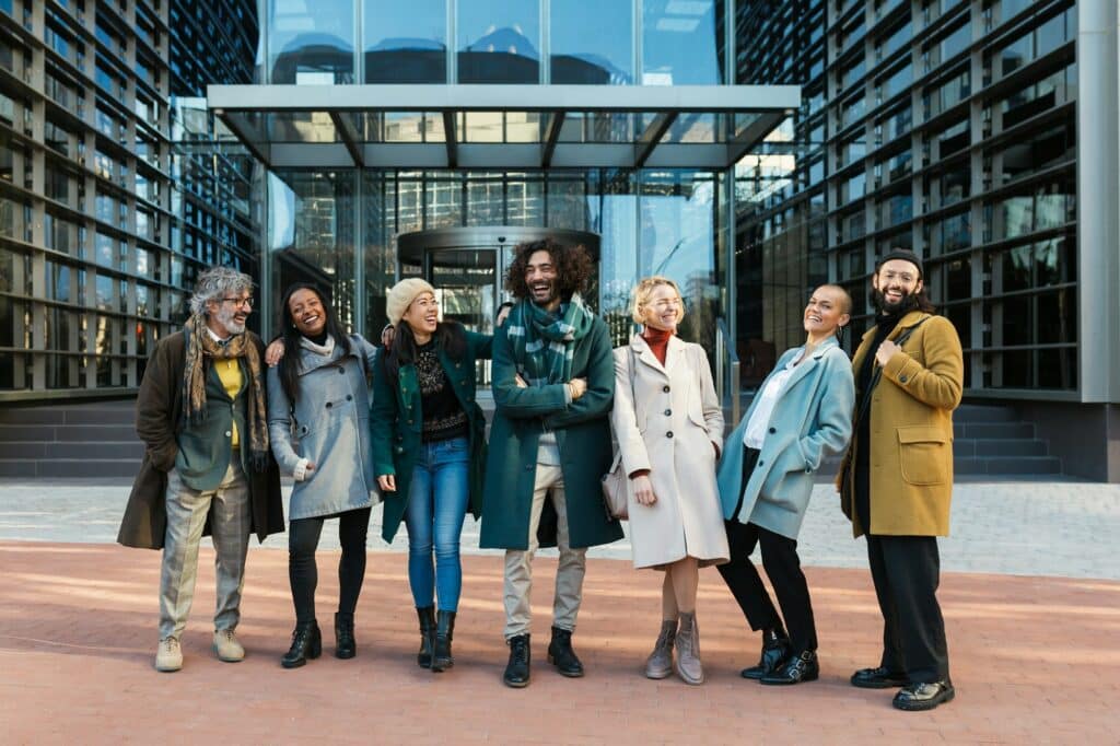 Diverse coworkers laughing on street before work together