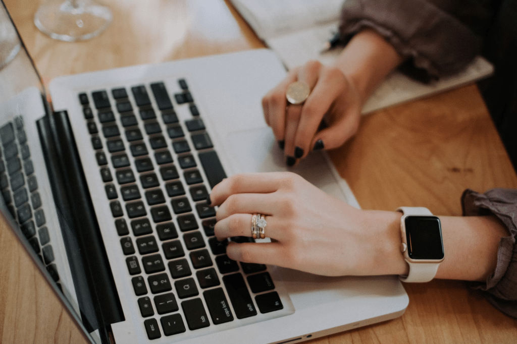 Woman with smart watch on MacBook (Image source: UnSplash)