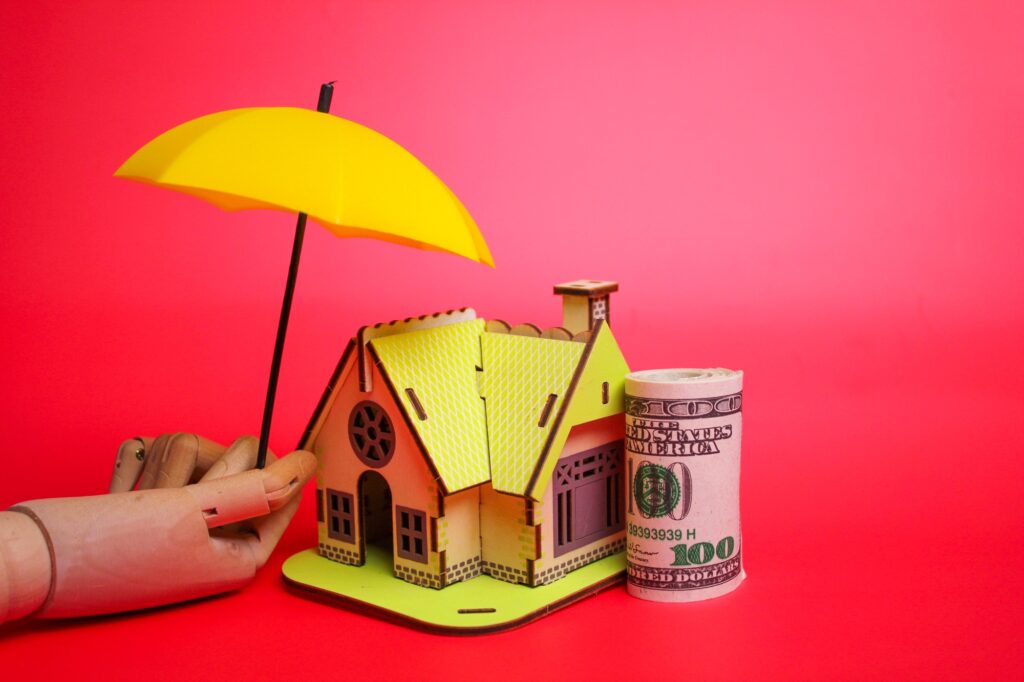 paper money, umbrellas protect the house. housing protection concept